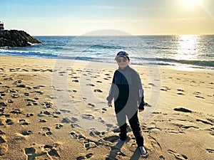 A teenager on the shore of the ocean