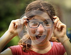 Teenager shortsighted girl with myopia wearing new sight correction glasses