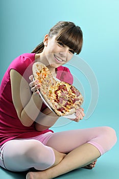 Teenager showing pizza