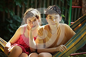 Teenager siblings boy and girl brother and sister close up summer outdoor photo