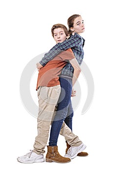 Teenager siblings hugging back on back