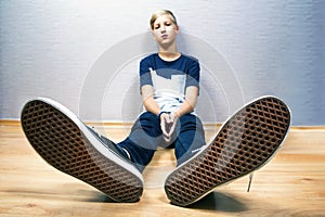 Teenager sits on a floor in the room