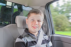 Teenager sitting in a car in safety chair