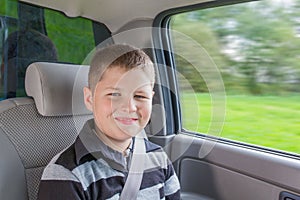 Teenager sitting in a car in safety chair