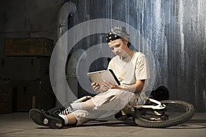 Teenager sitting with tablet pc