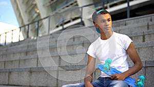 Teenager skateboarded waiting for friends to practice, active lifestyle, hobby photo