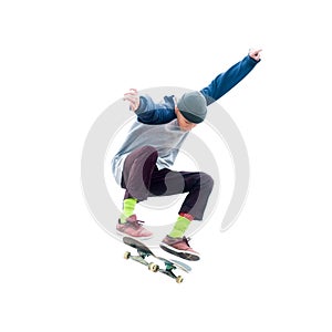 Teenager skateboarder jumps ollie on an isolated white background. The concept of street sports and urban culture photo