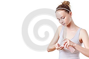 Teenager skincare. Smiling beautiful redhead teen girl with freckles and blue eyes using foaming cleanser.