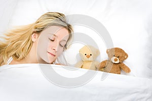 Teenager sleeping with teddies