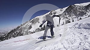 Teenager snowboarder woman jumps at kicker