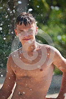 Teenager in a spray of water.