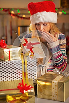 Teenager with stack of christmas present boxes