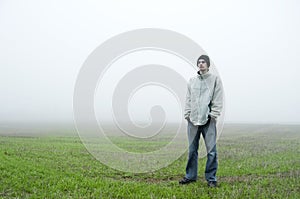 Teenager standing in field