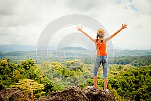 Teenager standing on a mountain top