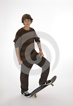 Teenager standing on skateboard