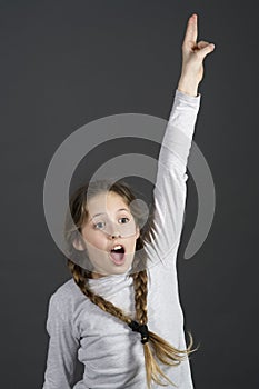 Teenager student girl knows the answer with hands up photo