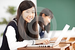 Teenager student learning online with laptop in classroom photo