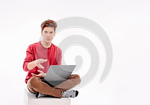 Teenager student working at laptop on white background