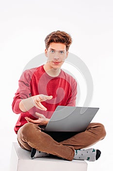 Teenager student working at laptop on white background