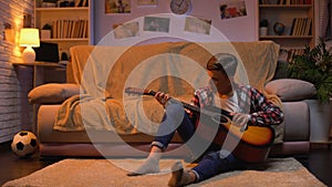 Teenager studying to play guitar dreaming about musician career hobby, lifestyle