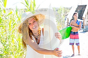 Teenager surfers waling to the beach