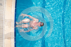 Teenager swims in pool