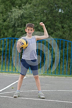 A teenager in a T-shirt and shorts celebrates the victory