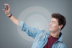 Teenager taking selfies with mobile phone