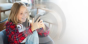 Teenager, technology and communication concept - smiling girl texting on smartphone with copy space