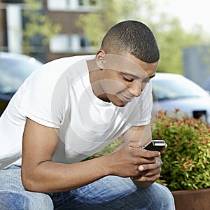 Teenager texting on his mobile