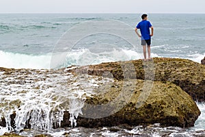 A teenager thinking and contemplating the ocean