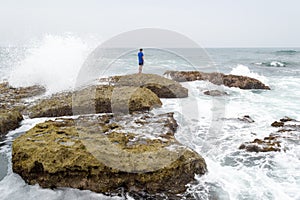 A teenager thinking and contemplating the ocean