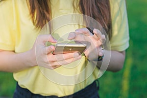 Teenager touching a screen. Woman holding a mobile phone in hands