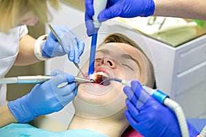 Teenager treating teeth caries or pulpitis in medical office