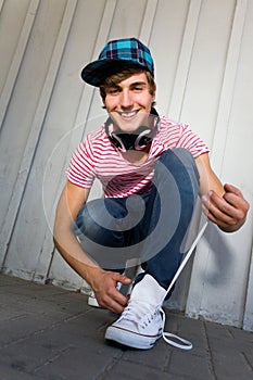 Teenager tying shoes