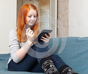 Teenager uses tablet computer or e-book