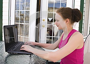 Teenager using laptop at home