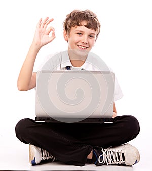 Teenager using laptop - ok gesture
