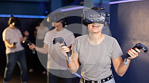 teenager in virtual reality glasses with joystick play survival game in tone jungle of future