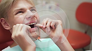 Teenager visits orthodontist man tries on aligners in clinic