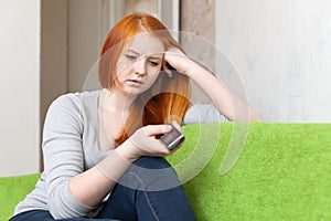 Teenager waits telephone call after quarrel photo