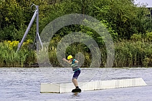 Teenager wakeboarding on a lake - Brwinow, Masovia, Poland photo