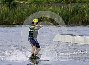 Teenager wakeboarding on a lake - Brwinow, Masovia, Poland photo