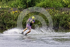 Teenager wakeboarding on a lake - Brwinow, Masovia, Poland photo