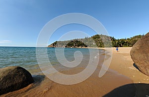 Teenager walking on beautiful tropical beach, QLD, Australia