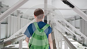 Teenager walking under the bridge. Cool footage in motion