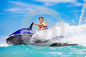 Teenager on water scooter. Teen age boy water skiing.