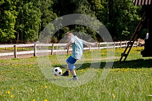 Teenagers Boys Playing Soccer Football Match. Young Football Players Running and Kicking Soccer Ball on a Soccer Pitch.