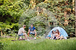 Teenagers camping in forest. Summer adventure.