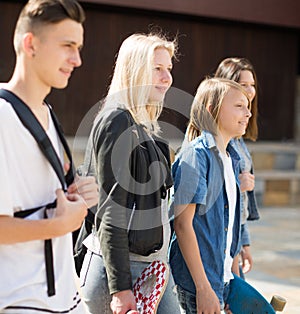 Teenagers communicate in schoolyard